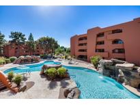 Community pool with waterfall feature at 4303 E Cactus Rd # 441, Phoenix, AZ 85032