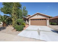 Single-story home with a two-car garage and landscaped front yard at 2448 E Fiesta Dr, Casa Grande, AZ 85194