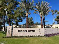 Biltmore Estates entrance with lush landscaping and palm trees at 5132 N 31St Way # 114, Phoenix, AZ 85016