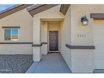 Dark brown front door with a small entryway and exterior light fixture at 8461 W Altos Dr, Arizona City, AZ 85123