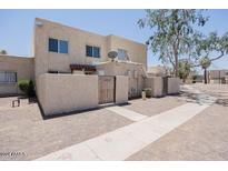 Front view of a light beige stucco townhome at 5418 W Belleview St, Phoenix, AZ 85043