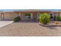 Charming single story home with a two-car garage and well-manicured lawn at 10415 W Pleasant Valley Rd, Sun City, AZ 85351