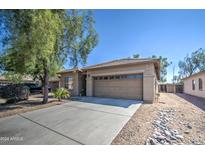 Single-story home with a two-car garage and desert landscaping at 913 S 115Th Dr, Avondale, AZ 85323