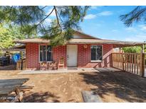 Brick home with covered patio and small fenced yard at 36626 W Papago Dr, Stanfield, AZ 85172