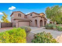 Two-story home with a large driveway and desert landscaping at 17797 W Carmen Dr, Surprise, AZ 85388