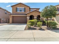 Two-story house with brown exterior, attached garage, and landscaping at 21243 W Coronado Rd, Buckeye, AZ 85396