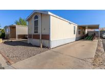 Mobile home with carport, ramp, and gravel driveway at 501 E Ray Rd # 211, Chandler, AZ 85225