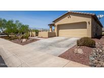 Single-car garage with desert landscaping and driveway at 17540 W Glenhaven Dr, Goodyear, AZ 85338