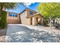Two-story house with attached garage and landscaping at 18535 W Udall Dr, Surprise, AZ 85374