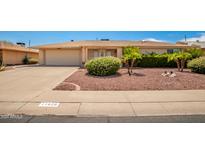 Front view of a single-story house with a two car garage at 11826 N Sun Valley Dr, Sun City, AZ 85351