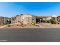 Single-story home with carport and desert landscaping at 11596 W Sierra Dawn Blvd # 377, Surprise, AZ 85378
