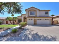 Two-story house with a three-car garage and landscaping at 695 W Estrella Dr, Gilbert, AZ 85233