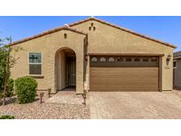 Tan two-car garage home with landscaped yard at 7930 W Pasadena Ave, Glendale, AZ 85303