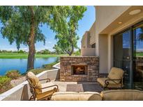 Relaxing patio with fireplace and lake view at 8989 N Gainey Center Dr # 114, Scottsdale, AZ 85258