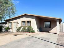 Single-story house with a driveway and well-maintained landscaping at 3610 W Abraham Ln, Glendale, AZ 85308