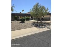 Ranch style home with gravel landscaping and driveway at 10617 W Deanne Dr, Sun City, AZ 85351