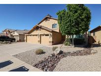 Two-story house with a three-car garage and landscaped yard at 26028 N 66Th Dr, Phoenix, AZ 85083