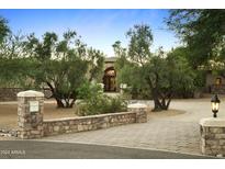 Grand entrance with stonework and mature olive trees at 6324 N 48Th Pl, Paradise Valley, AZ 85253