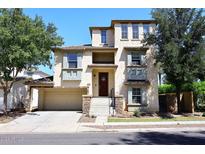 Three-story home with a two-car garage and stonework at 4306 E Tyson St, Gilbert, AZ 85295