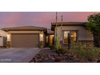 Single-story home with a two-car garage and desert landscaping at 18211 W Sequoia Dr, Goodyear, AZ 85338