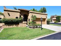 Spanish style home with landscaped lawn and two-car garage at 23014 N 86Th St, Scottsdale, AZ 85255