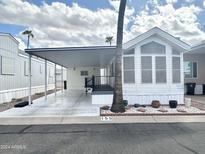Single wide manufactured home with carport and landscaping at 155 S Limestone Dr, Apache Junction, AZ 85119