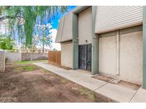 View of building exterior with gated entrance and walkway at 5921 W Golden Ln, Glendale, AZ 85302