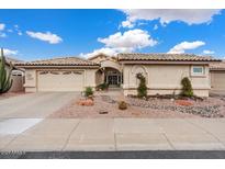 Tan two-story house with a two-car garage and desert landscaping at 14194 W Mountain Laurel Trl, Surprise, AZ 85374