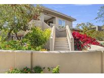 Two story home with stucco exterior, landscaping, and stairs at 8420 N 15Th St, Phoenix, AZ 85020