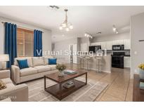 Virtually staged living room with kitchen view at 4386 E Selena Dr, Phoenix, AZ 85050