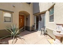 Private courtyard with seating, a water feature and a sliding glass door at 20802 N Grayhawk Dr # 1026, Scottsdale, AZ 85255