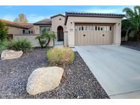 Single-story home with attached garage and desert landscaping at 13049 W Redbird Rd, Peoria, AZ 85383