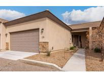 Tan colored home with a two-car garage and walkway at 846 N Pueblo Dr # 126, Casa Grande, AZ 85122