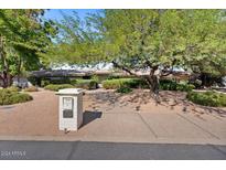 Front view of a single story home with mature landscaping at 6516 E Maverick Rd, Paradise Valley, AZ 85253