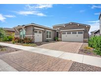Two-story home with a two-car garage and nicely landscaped yard at 10020 E Strobe Ave, Mesa, AZ 85212