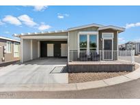 Mobile home with carport, modern exterior, and small front yard at 8865 E Baseline Rd # 753, Mesa, AZ 85209