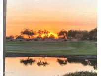 Peaceful sunset view over a tranquil lake and golf course at 2942 S First Water Ln, Gold Canyon, AZ 85118