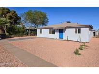 Charming single story home with blue door and gravel yard at 5011 S 20Th Pl, Phoenix, AZ 85040