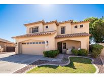 Two-story house with a tan exterior, landscaped lawn, and a two-car garage at 8129 W Ross Ave, Peoria, AZ 85382