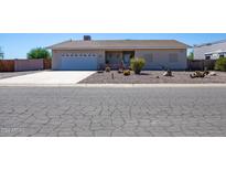Ranch-style home with a single-car garage and well-maintained landscaping at 8183 W Raven Dr, Arizona City, AZ 85123
