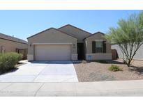 House front with two-car garage and landscaping at 31021 W Columbus Ave, Buckeye, AZ 85396