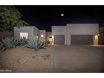 Night view of a modern home with two-car garage at 7056 E Mighty Saguaro Way, Scottsdale, AZ 85266