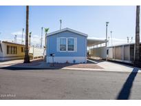 Charming light blue manufactured home with covered carport at 2601 E Allred Ave # Br24, Mesa, AZ 85204