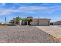 Two-story house with three-car garage and gravel driveway at 127 E Sabrosa Dr, New River, AZ 85087