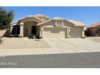 Beautiful two-story home with a three-car garage and desert landscaping at 20411 N 99Th Dr, Peoria, AZ 85382