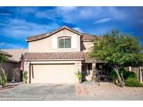 Two-story house with tan exterior and a two car garage at 29101 N Yellow Bee Dr, San Tan Valley, AZ 85143