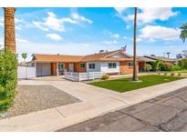 Charming Ranch style home with a well-maintained lawn at 8408 E Sheridan St, Scottsdale, AZ 85257