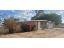 Mid-century modern home with attached garage at 5937 W Coolidge St, Phoenix, AZ 85033