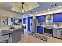 Modern kitchen with blue cabinets and stainless steel appliances at 4525 N 66Th St # 48, Scottsdale, AZ 85251