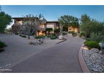 Luxury home with stone facade and landscaped driveway at 10626 E Palo Brea Dr, Scottsdale, AZ 85262